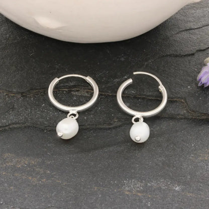 Get your Pearl Drift Natural White Oval Pearl Hoop Earrings online now or in store at Forever Gems in Franschhoek, South Africa
